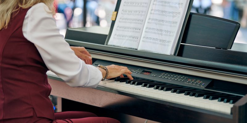A person playing a digital piano