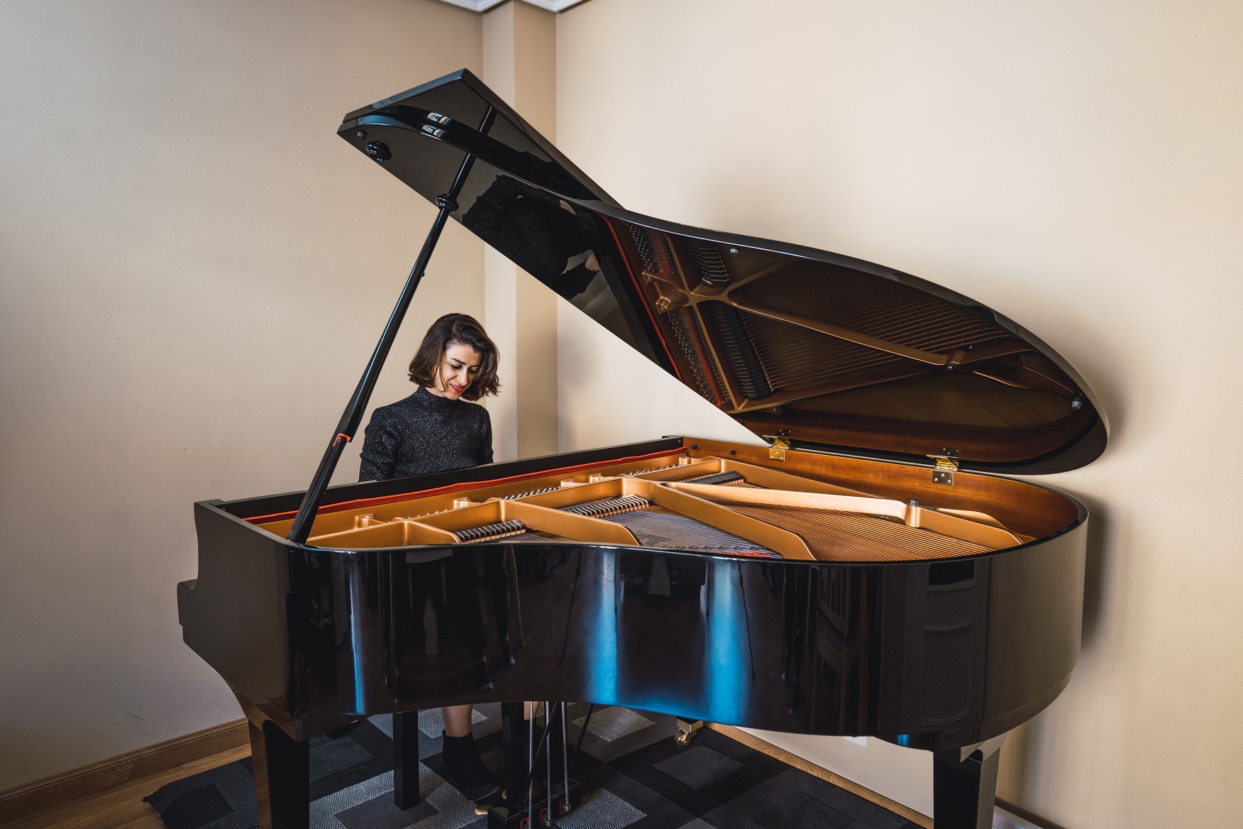 Young woman playing a grand piano